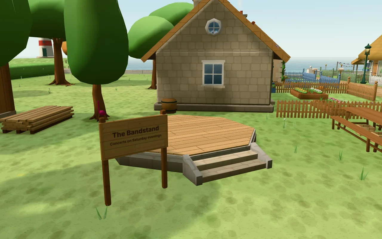 Actual CozyWorld Village screenshot: the bandstand partly built on the green: the new plank floor laid on the old stone base, a stack of planks waiting nearby and the sign promising concerts on Saturday evenings.